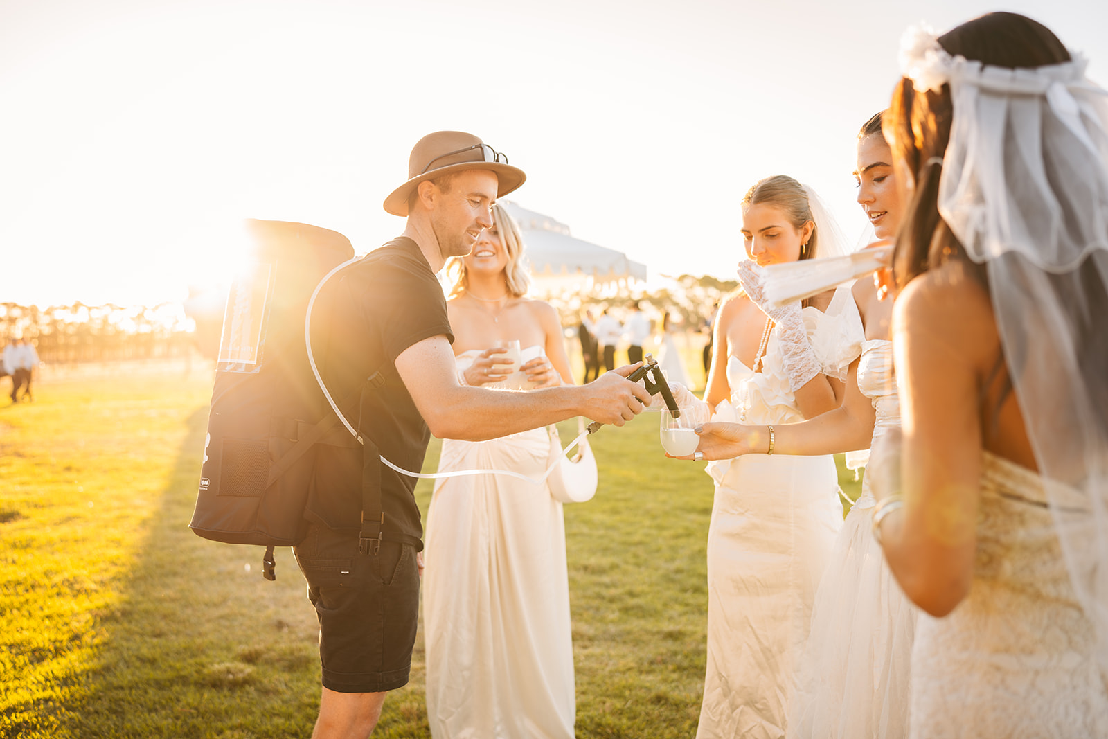 Park 'n' Pour Walk 'n' Pour roaming keg backpack pouring drinks for wedding guests at golden hour